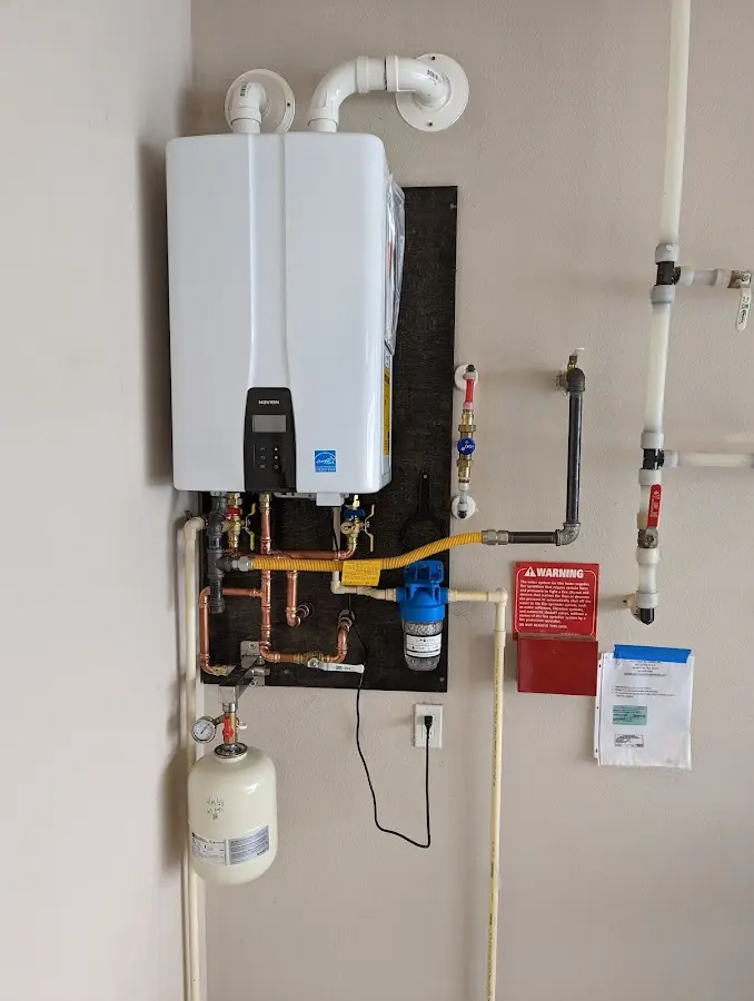 Professional plumber installing copper piping in a West St. Paul home